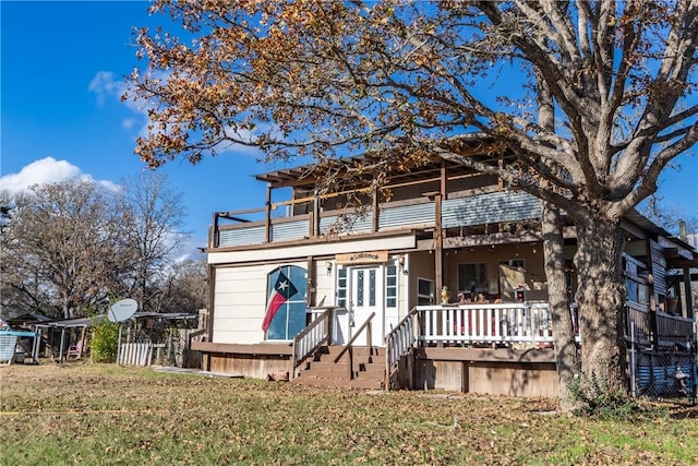 view of front of house with a balcony and a front yard