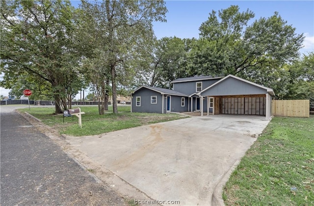 ranch-style home featuring a front yard and a carport