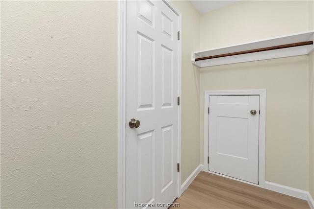 corridor with light wood-type flooring