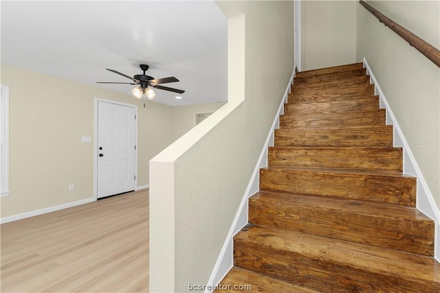 stairs with ceiling fan and wood-type flooring