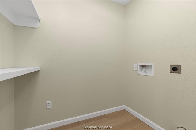 laundry area with electric dryer hookup, hookup for a washing machine, and wood-type flooring