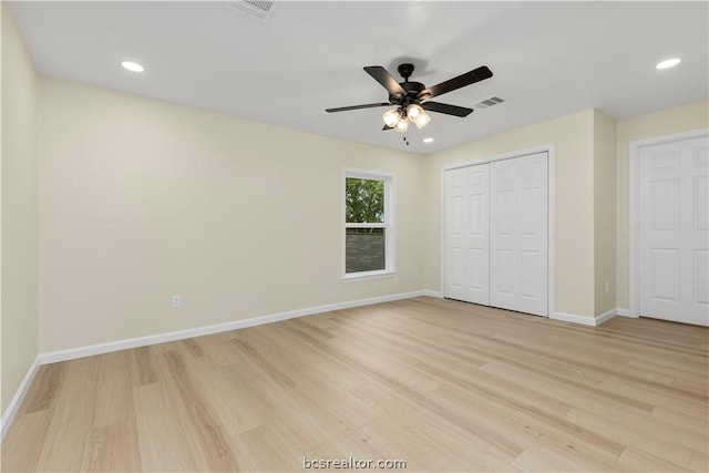 unfurnished bedroom featuring a closet, light hardwood / wood-style floors, and ceiling fan