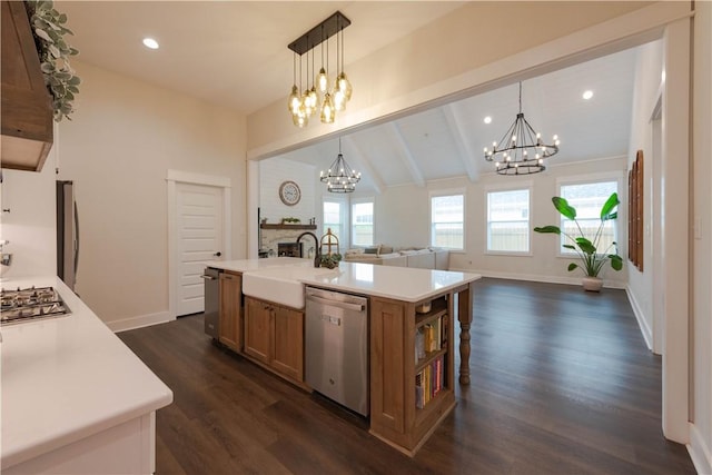 kitchen featuring vaulted ceiling with beams, a center island with sink, stainless steel appliances, and a healthy amount of sunlight