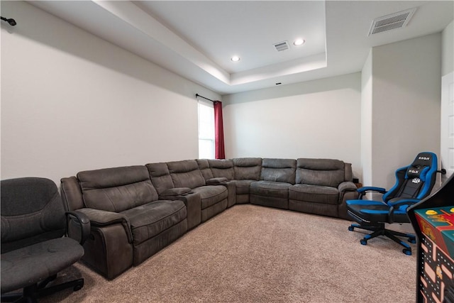 carpeted living room featuring a tray ceiling