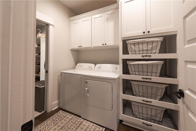 laundry area with cabinets, independent washer and dryer, and light hardwood / wood-style flooring