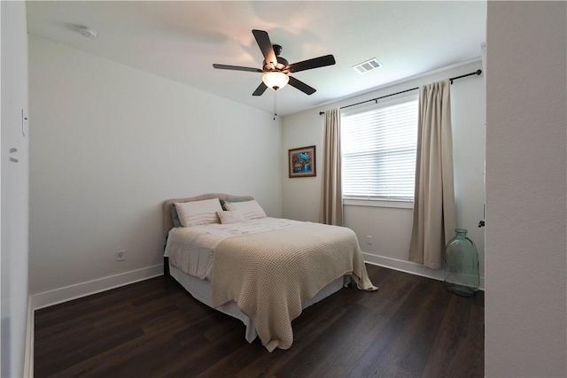 bedroom with dark hardwood / wood-style flooring and ceiling fan