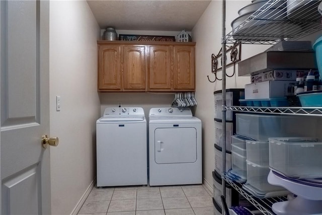 919 Alan Ln, Caldwell, TX 77836 - washroom with washer and clothes dryer, cabinet space, and light tile patterned flooring