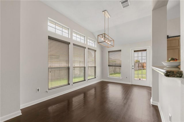 2031 Positano Loop, Bryan, TX 77808 - unfurnished dining area featuring a chandelier, baseboards, and dark wood-type flooring