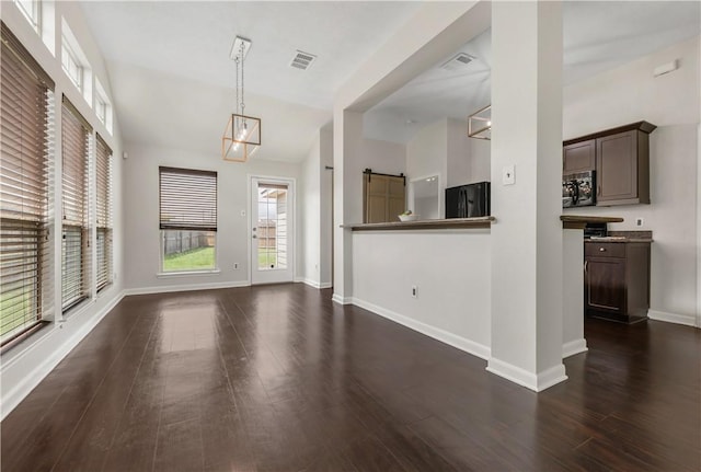2031 Positano Loop, Bryan, TX 77808 - unfurnished living room featuring dark wood-type flooring, baseboards, and vaulted ceiling