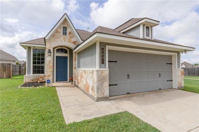 2031 Positano Loop, Bryan, TX 77808 - view of front of home with stone siding, an attached garage, and concrete driveway