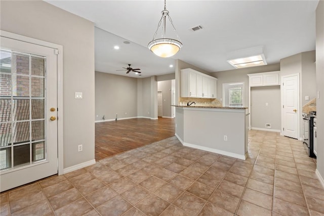 kitchen featuring white cabinets, pendant lighting, baseboards, ceiling fan, and recessed lighting