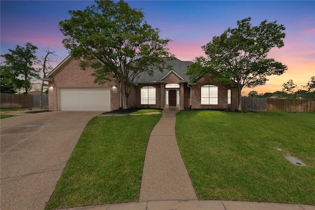 view of front of home with concrete driveway, an attached garage, and brick siding