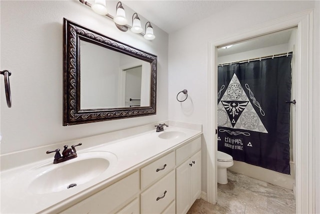 bathroom featuring curtained shower, vanity, and toilet