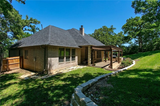 back of property featuring a pergola, a yard, and a patio