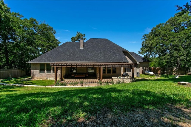 rear view of house featuring a lawn