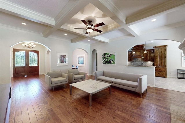 living room with beamed ceiling, dark hardwood / wood-style flooring, and french doors