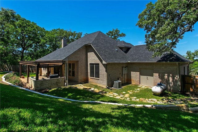 rear view of property featuring a yard, a patio area, and central air condition unit