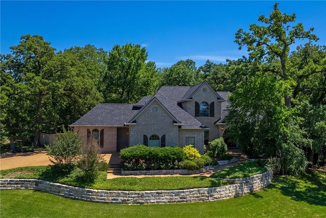 french country style house with a front yard