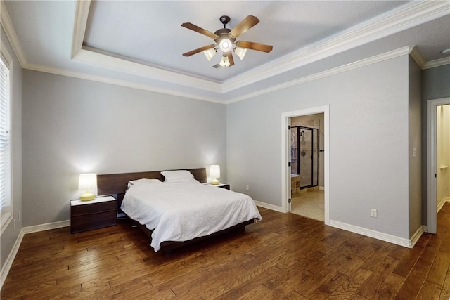 bedroom with hardwood / wood-style floors, a raised ceiling, ceiling fan, and crown molding