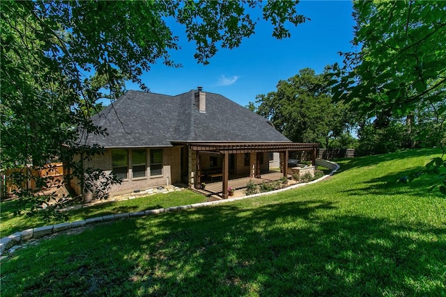 back of house featuring a lawn and a patio