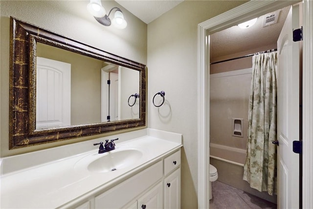 full bathroom with vanity, shower / bath combination with curtain, tile patterned flooring, toilet, and a textured ceiling