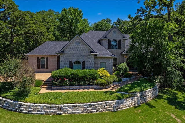 french country home with a front lawn