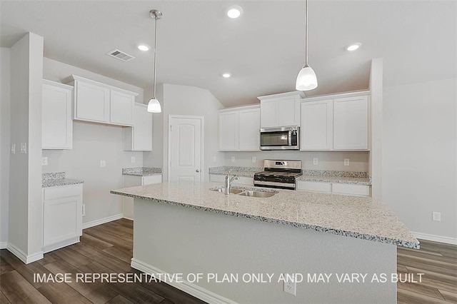 kitchen with appliances with stainless steel finishes, white cabinetry, dark wood-type flooring, and sink