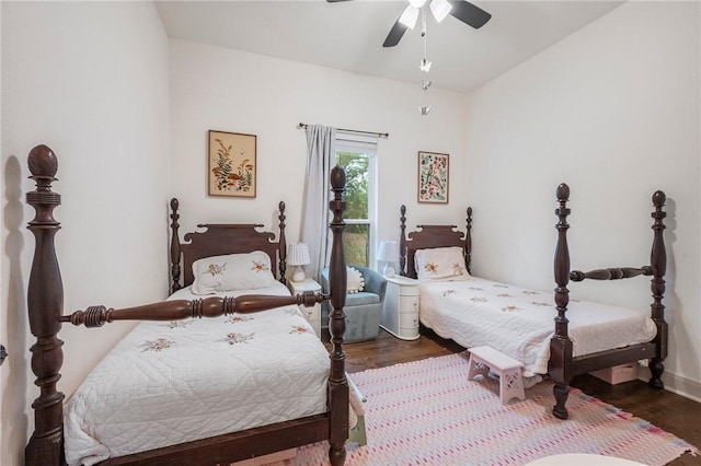 bedroom featuring ceiling fan, baseboards, and dark wood-style flooring