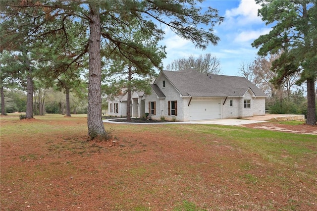 modern farmhouse featuring a garage, concrete driveway, and a front yard