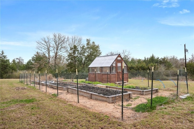 view of yard with an exterior structure, an outbuilding, a garden, and fence