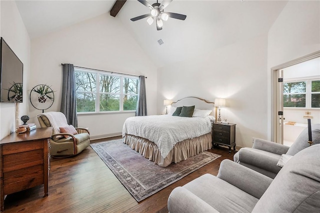 bedroom with beamed ceiling, dark wood-type flooring, and multiple windows