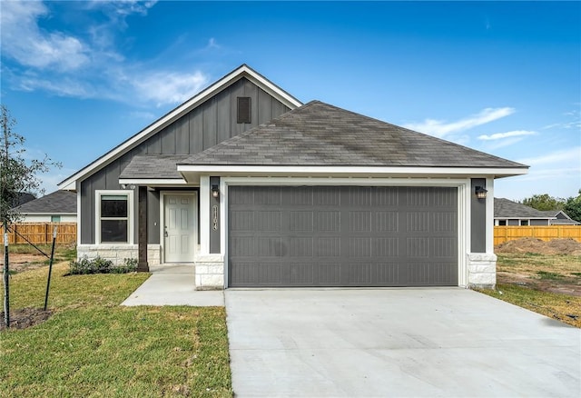 view of front facade with a front yard and a garage