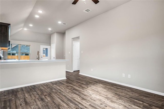 interior space with dark hardwood / wood-style floors, vaulted ceiling, ceiling fan, and sink