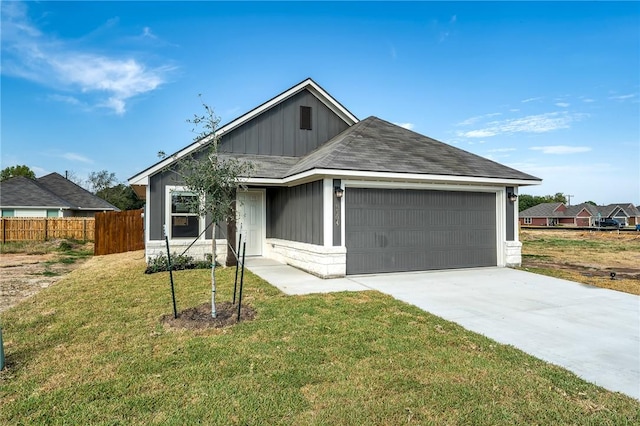 ranch-style home featuring a garage and a front lawn