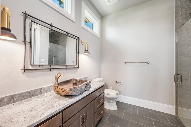 4724 Concordia Dr, Bryan, TX 77802 - bathroom featuring toilet, tile patterned floors, a stall shower, vanity, and baseboards