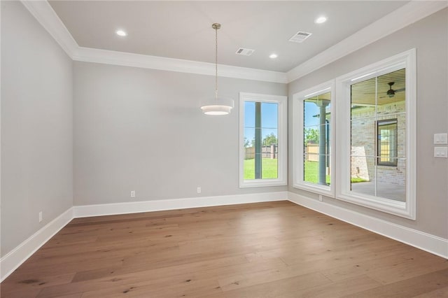 4724 Concordia Dr, Bryan, TX 77802 - unfurnished dining area featuring wood finished floors, visible vents, and crown molding