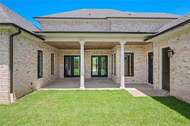 4724 Concordia Dr, Bryan, TX 77802 - back of property with brick siding, a yard, french doors, and a patio area