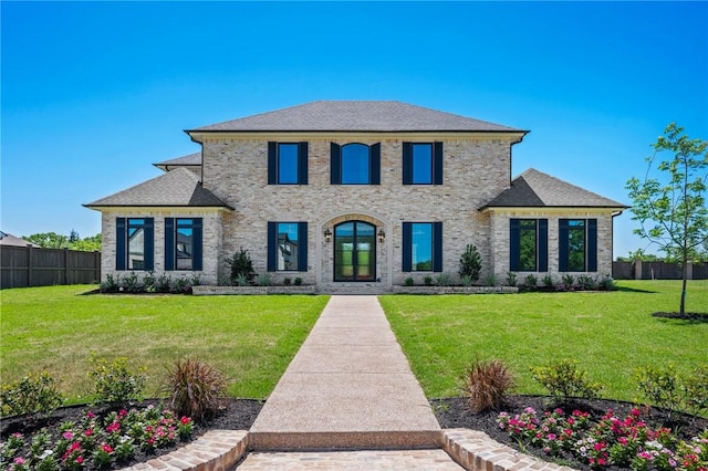 4724 Concordia Dr, Bryan, TX 77802 - view of front of home with brick siding, a shingled roof, a front yard, and fence