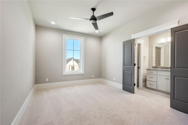 4724 Concordia Dr, Bryan, TX 77802 - unfurnished bedroom featuring connected bathroom, baseboards, visible vents, and light carpet