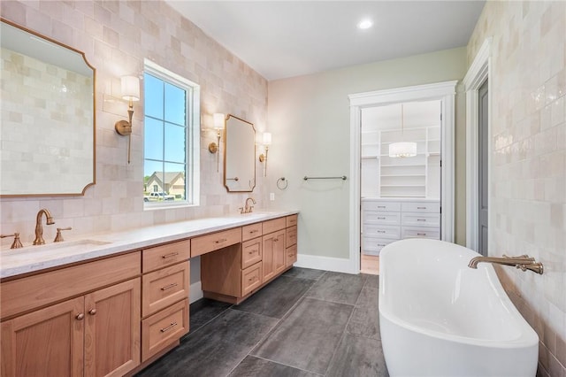 4724 Concordia Dr, Bryan, TX 77802 - full bath featuring a soaking tub, decorative backsplash, a sink, and double vanity