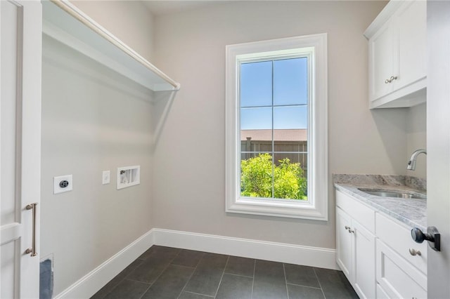 4724 Concordia Dr, Bryan, TX 77802 - washroom featuring a sink, baseboards, washer hookup, cabinet space, and electric dryer hookup