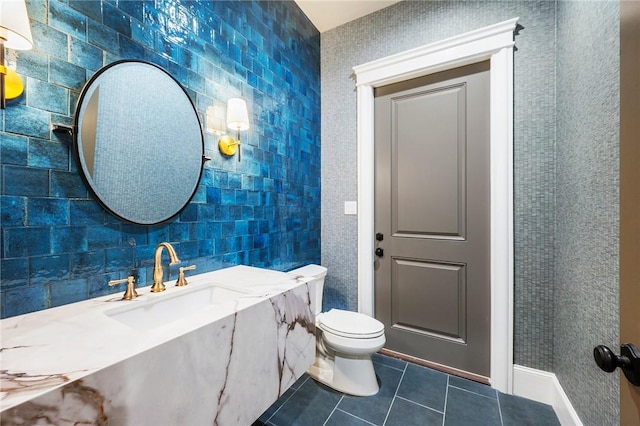 4724 Concordia Dr, Bryan, TX 77802 - bathroom with toilet, tile patterned flooring, a sink, and tile walls