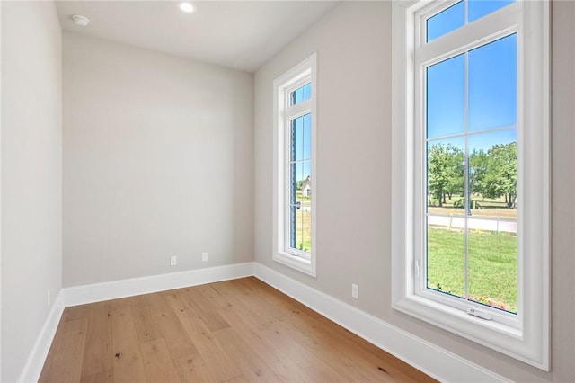 4724 Concordia Dr, Bryan, TX 77802 - spare room with baseboards, a wealth of natural light, and light wood-style floors