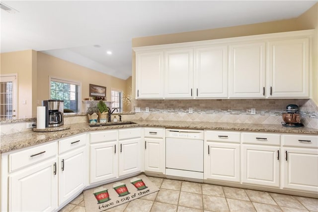 kitchen with white cabinetry, dishwasher, sink, decorative backsplash, and light tile patterned floors