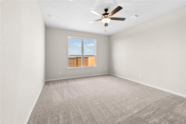 spare room with carpet floors and ceiling fan