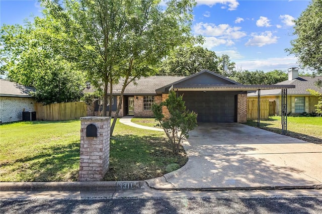 ranch-style home featuring an attached garage, cooling unit, a front yard, and fence