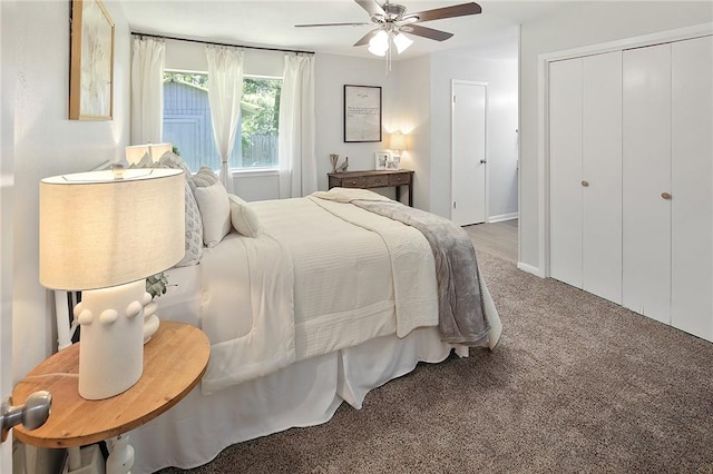 carpeted bedroom featuring a closet and a ceiling fan