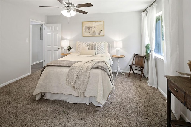 carpeted bedroom featuring baseboards and a ceiling fan