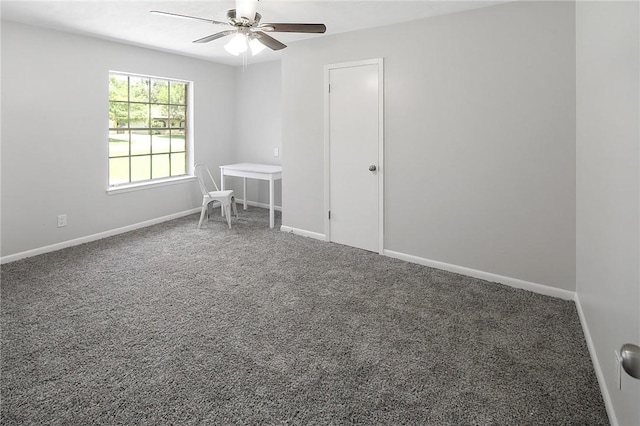 carpeted empty room with ceiling fan and baseboards