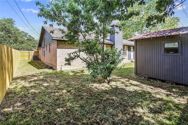 view of yard with a fenced backyard and an outdoor structure